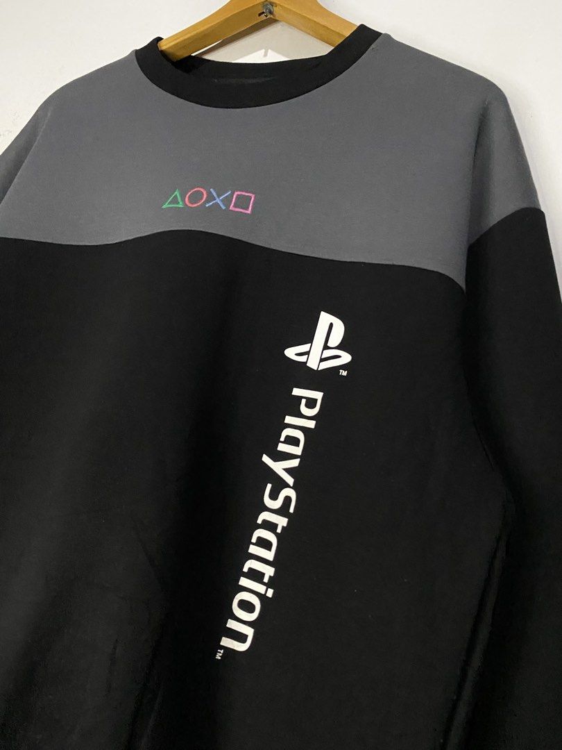 LONGSLEEVED (Category: Hoodies) located in Jaen. Submitted by oshimamark58418 (Listing ID 1467453360, Image 3). Description: - Official PlayStation long-sleeved top - Colorblock design in grey and black with black collar and cuffs - Embroidered controller button icons (Triangle, Circle, Cross, Square) on the upper chest - Vertical PlayStation logo printed on the lower left front - Tagged Size: S (Actual measured dimensions: 22" width x 28" length