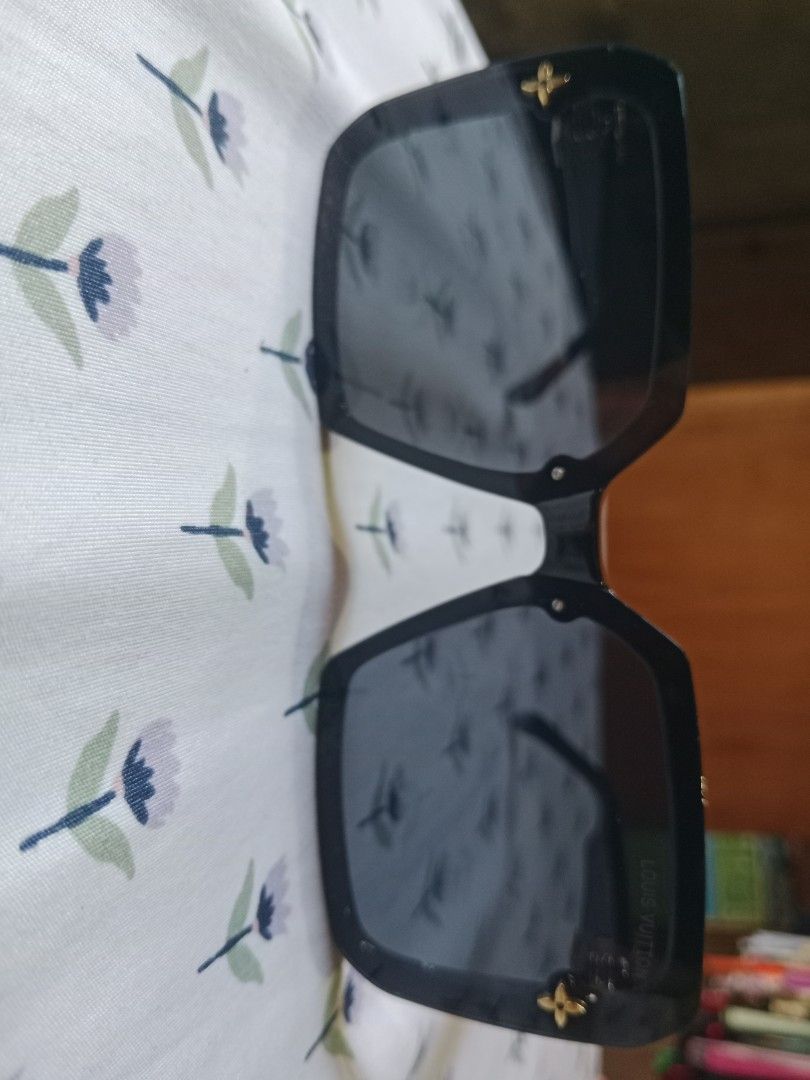 Louis Vuitton Black Square Sunglasses with Case (Category: Sunglasses & Eyewear) located in San Miguel. Submitted by chriswajer65155 (Listing ID 1467375892, Image 3). Description: - Brand: Louis Vuitton - Style: Black oversized square sunglasses - Details: Gold-tone LV initials on temples, signature monogram flower on hinges and frame corners - Lenses: Dark tinted with subtle logo text (zero scratches noticed) - Condition: Clean, well-maintained 