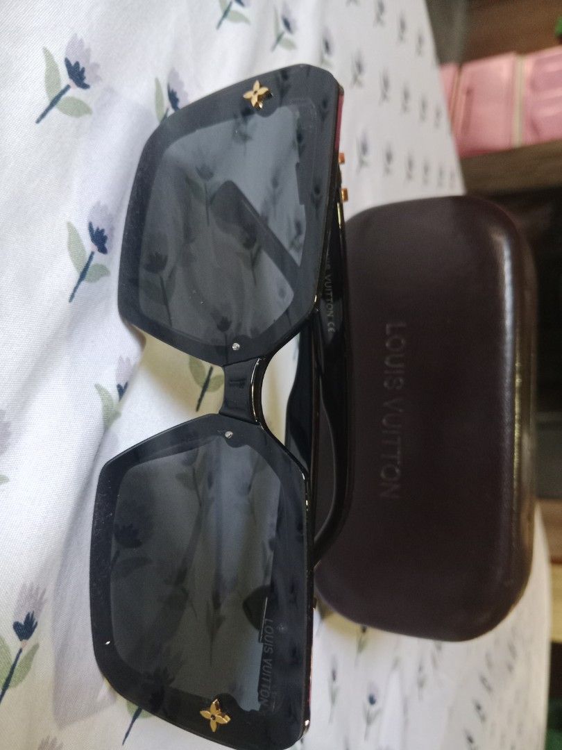 Louis Vuitton Black Square Sunglasses with Case (Category: Sunglasses & Eyewear) located in San Miguel. Submitted by chriswajer65155 (Listing ID 1467375892, Image 1). Description: - Brand: Louis Vuitton - Style: Black oversized square sunglasses - Details: Gold-tone LV initials on temples, signature monogram flower on hinges and frame corners - Lenses: Dark tinted with subtle logo text (zero scratches noticed) - Condition: Clean, well-maintained 