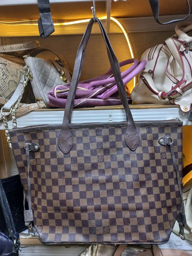 Louis Vuitton Damier Ebene Neverfull Tote Bag (Category: Luxury Bags & Wallets) located in Manila. Submitted by del_thrifts03 (Listing ID 1467375248, Image 2). Description: - Brand/Model: Louis Vuitton Damier Ebene Canvas Tote - Print: Classic brown and dark brown checkerboard - Features: Double leather shoulder straps, adjustable side laces, and spacious interior - Condition: Minor wear on leather trim/edges, slight hardware fading, clean interi