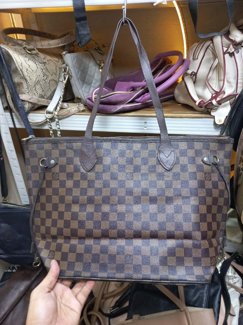 Louis Vuitton Damier Ebene Neverfull Tote Bag (Category: Luxury Bags & Wallets) located in Manila. Submitted by del_thrifts03 (Listing ID 1467375248, Image 1). Description: - Brand/Model: Louis Vuitton Damier Ebene Canvas Tote - Print: Classic brown and dark brown checkerboard - Features: Double leather shoulder straps, adjustable side laces, and spacious interior - Condition: Minor wear on leather trim/edges, slight hardware fading, clean interi
