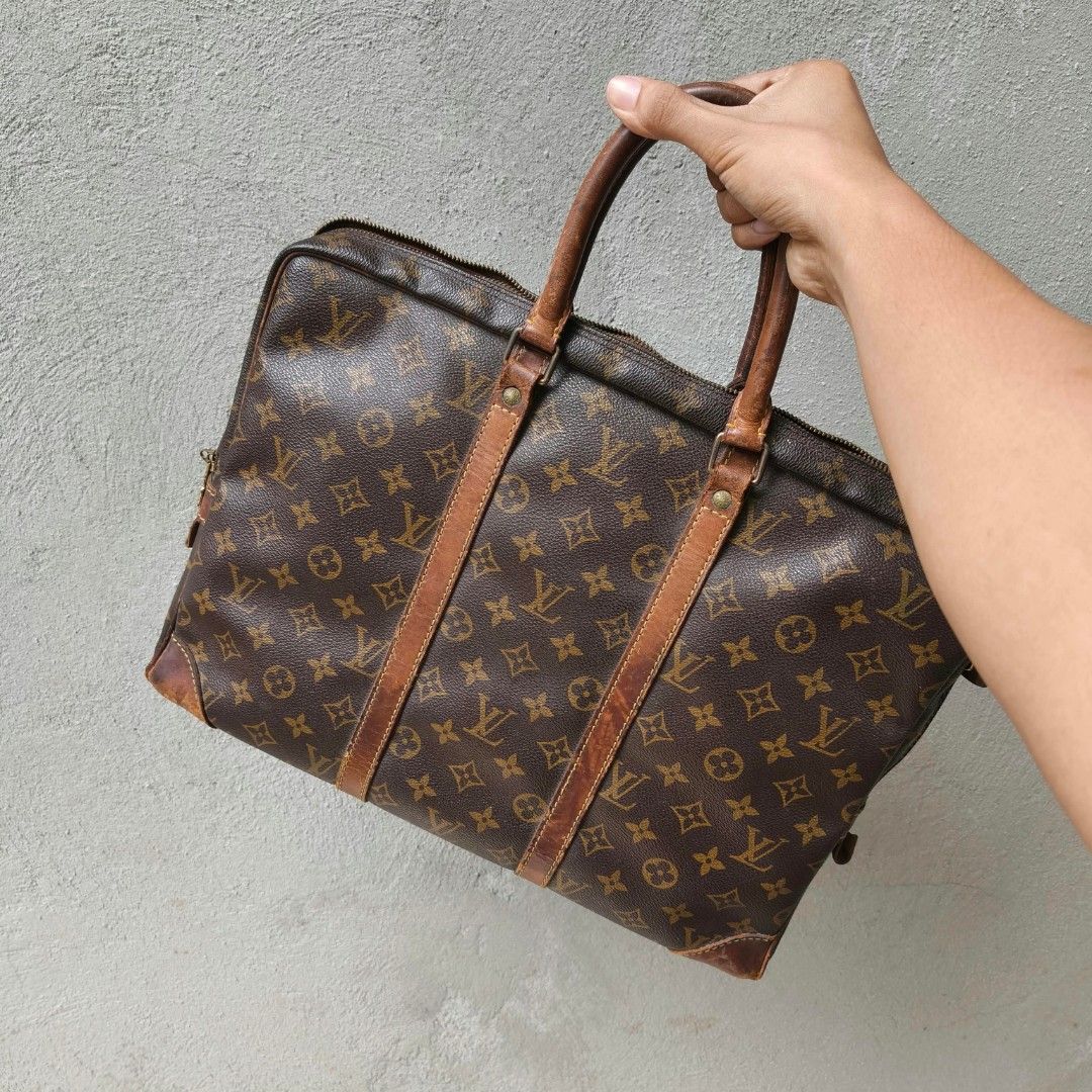 Louis Vuitton Monogram Briefcase Handbag (Category: Luxury Bags & Wallets) located in Lapu Lapu. Submitted by margaux099 (Listing ID 1467461298, Image 1). Description: - Classic brown monogram canvas design - Dual top handles and stylish vertical front leather straps - Brass hardware featuring a padlock (stamped Made in France) and engraved zipper pulls - Side metal rings with LV stamp details - Spacious interior for daily documents and essential