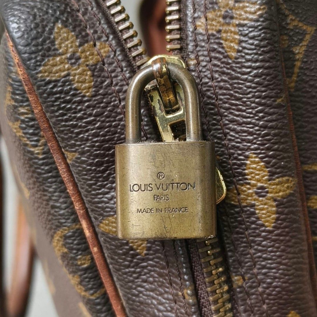 Louis Vuitton Monogram Briefcase Handbag (Category: Luxury Bags & Wallets) located in Lapu Lapu. Submitted by margaux099 (Listing ID 1467461298, Image 3). Description: - Classic brown monogram canvas design - Dual top handles and stylish vertical front leather straps - Brass hardware featuring a padlock (stamped Made in France) and engraved zipper pulls - Side metal rings with LV stamp details - Spacious interior for daily documents and essential
