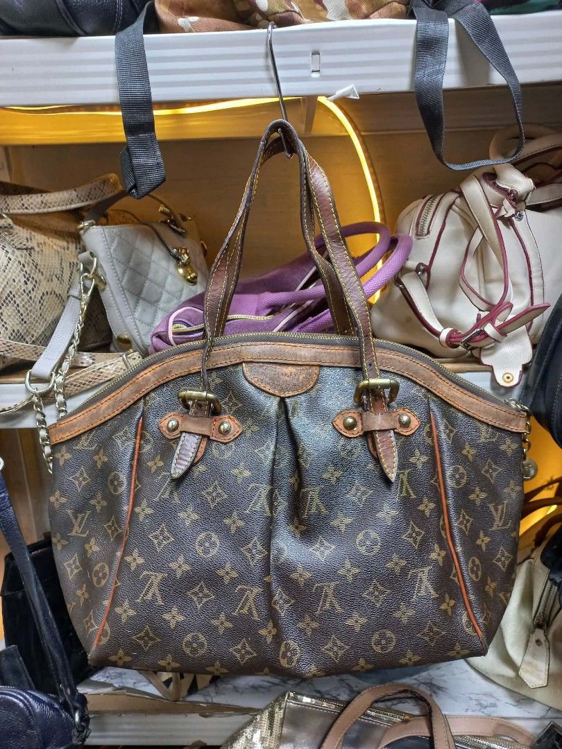 Louis Vuitton Monogram Canvas Shoulder Bag (Category: Luxury Bags & Wallets) located in Manila. Submitted by del_thrifts03 (Listing ID 1467375526, Image 1). Description: - Brown monogram canvas shoulder bag with matching leather trim - Dual top handles for comfortable shoulder or hand carry - Secure zip top closure to keep your belongings safe - Vibrant orange fabric interior lining equipped with handy slip pockets - Elegant brass tone hardware d