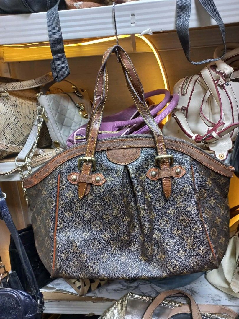 Louis Vuitton Monogram Canvas Shoulder Bag (Category: Luxury Bags & Wallets) located in Manila. Submitted by del_thrifts03 (Listing ID 1467375526, Image 2). Description: - Brown monogram canvas shoulder bag with matching leather trim - Dual top handles for comfortable shoulder or hand carry - Secure zip top closure to keep your belongings safe - Vibrant orange fabric interior lining equipped with handy slip pockets - Elegant brass tone hardware d