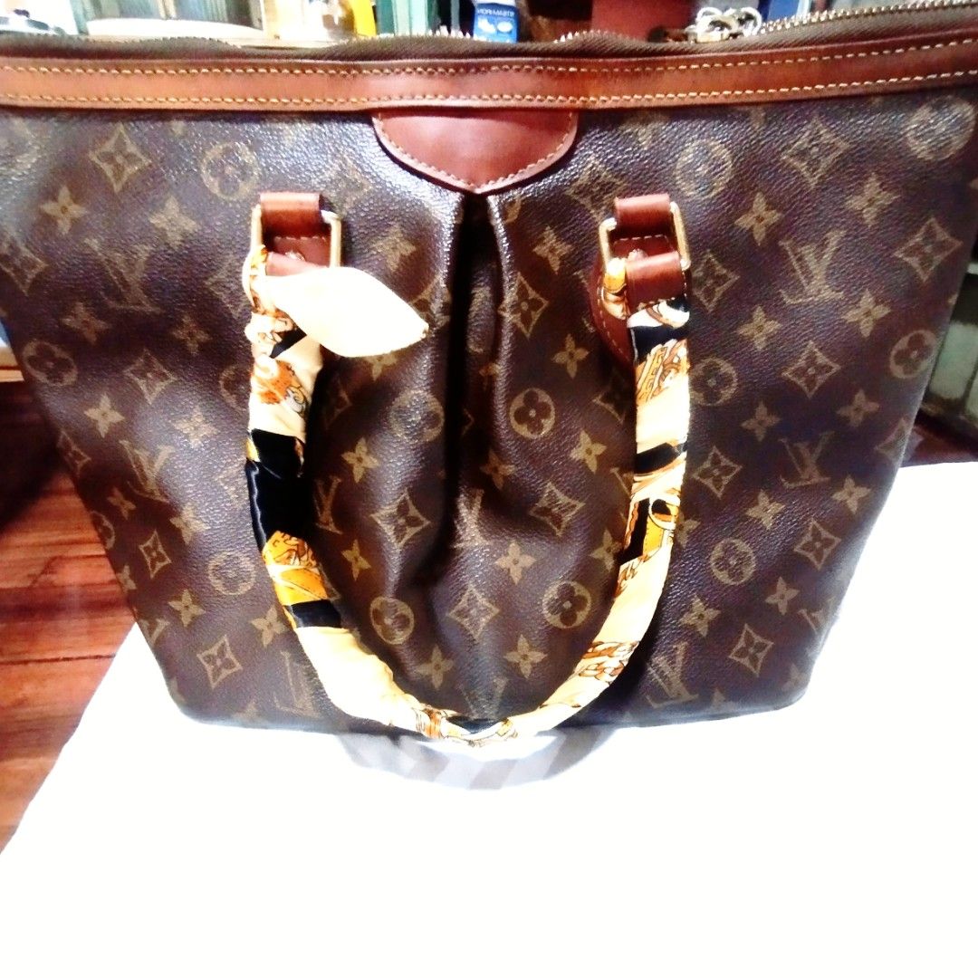 Louis Vuitton Monogram Canvas Handbag (Category: Tote Bags) located in Manila. Submitted by lene48 (Listing ID 1467413016, Image 3). Description: - Classic brown monogram canvas tote bag - Dark leather trim and twin top handles with decorative silk twill scarf - Secure zipper closure across the top - Stylish soft pleated design on the front panel - Clean and spacious interior lining - Elegant gold-tone hardware throughout.