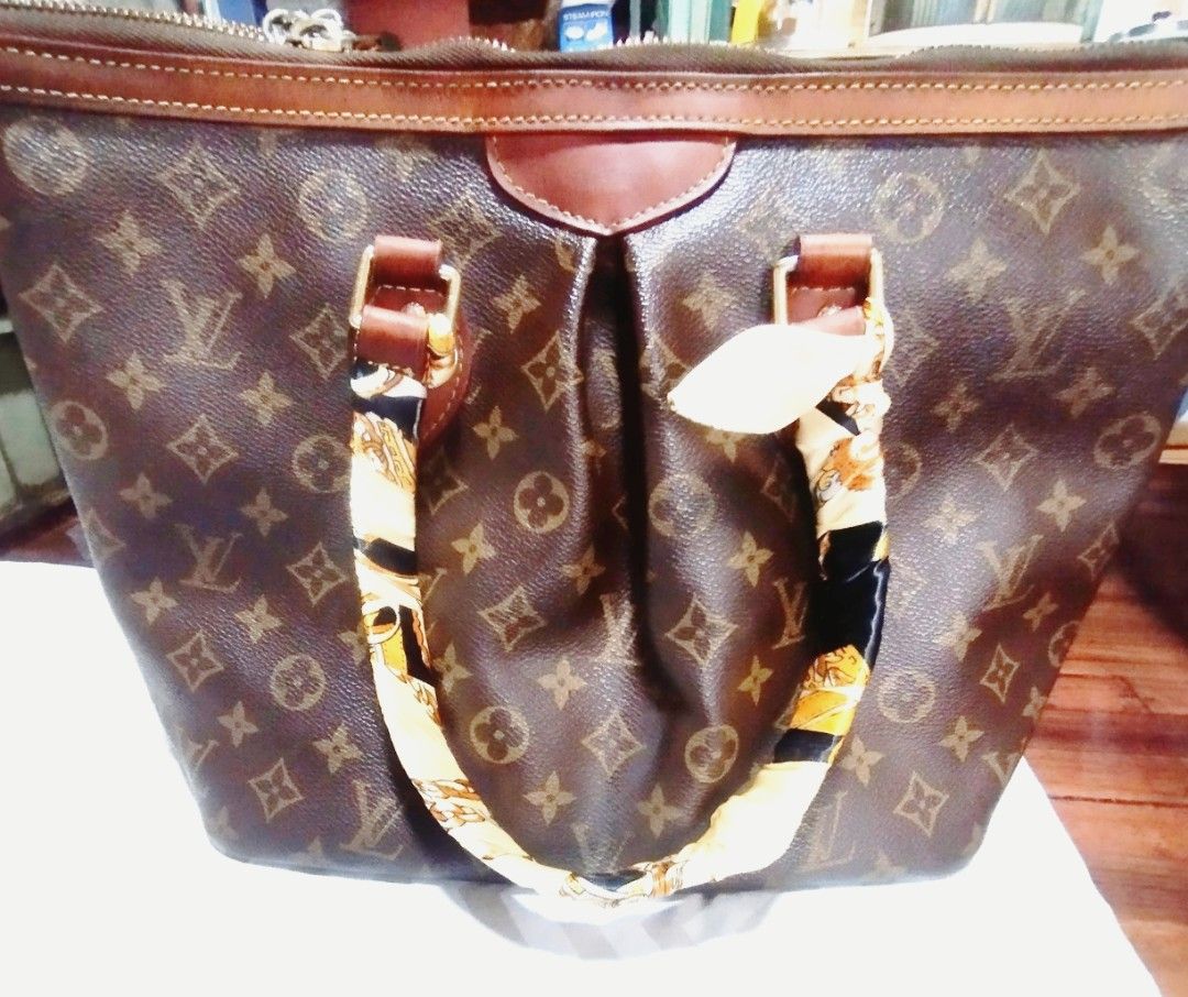 Louis Vuitton Monogram Canvas Handbag (Category: Tote Bags) located in Manila. Submitted by lene48 (Listing ID 1467413016, Image 1). Description: - Classic brown monogram canvas tote bag - Dark leather trim and twin top handles with decorative silk twill scarf - Secure zipper closure across the top - Stylish soft pleated design on the front panel - Clean and spacious interior lining - Elegant gold-tone hardware throughout.