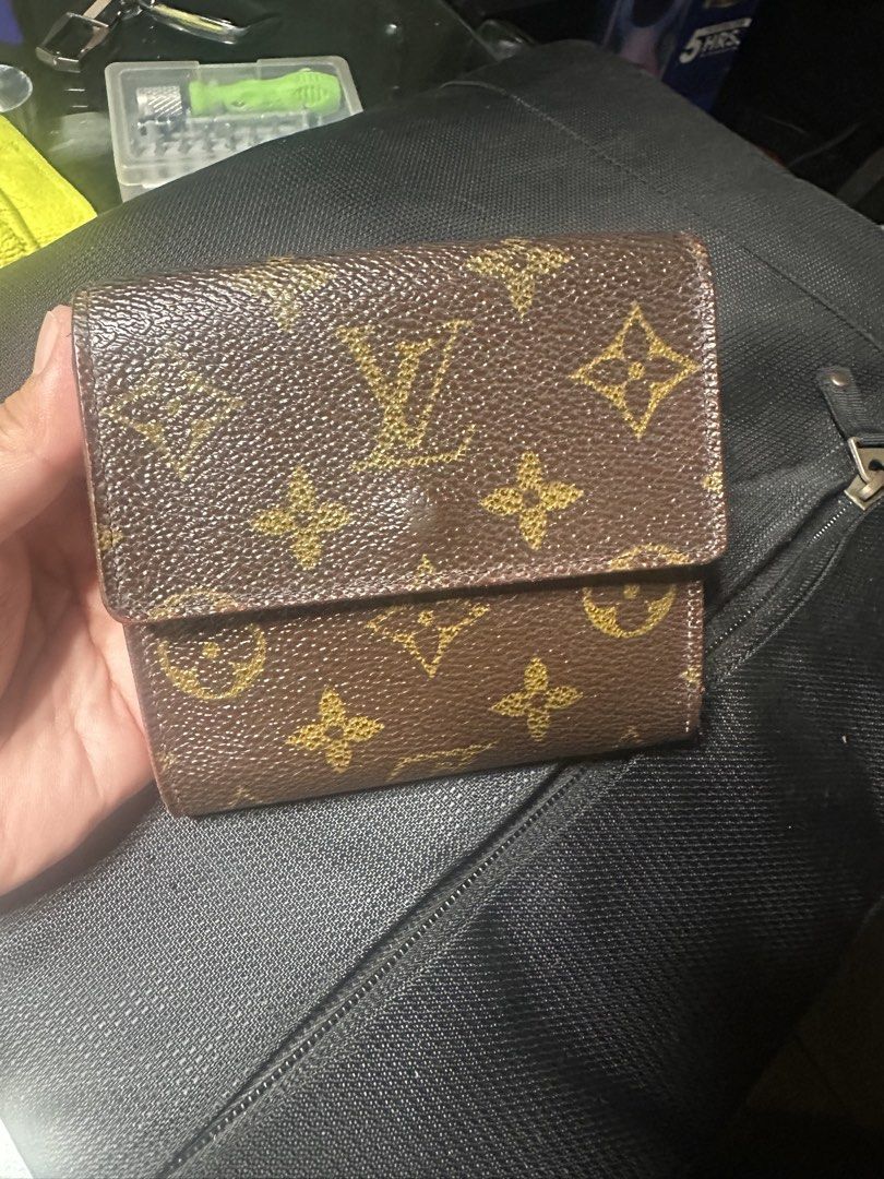 Louis Vuitton Monogram Canvas Compact Wallet (Category: Luxury Bags & Wallets) located in Marilao. Submitted by curleylux (Listing ID 1467475858, Image 2). Description: - Authentic Louis Vuitton folding wallet - Classic brown monogram canvas with gold-tone snap button closure - Brown cross-grain leather interior with multiple card slots and compartments - Condition: Shows visible signs of wear and rubbing on edges and corners from daily use - Per