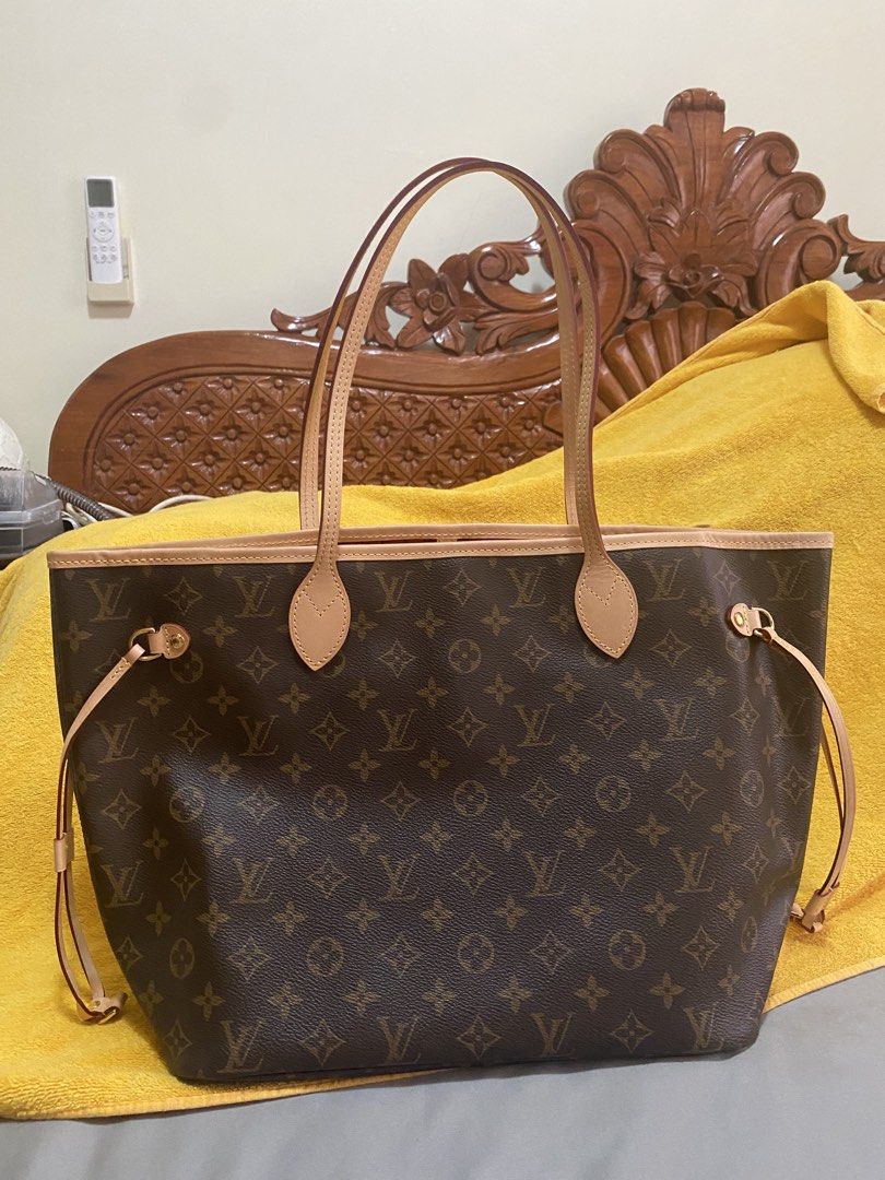 Louis Vuitton Monogram Neverfull MM Tote Bag (Category: Luxury Bags & Wallets) located in San Pablo. Submitted by butterfly1987_ (Listing ID 1467600204, Image 1). Description: - Authentic Monogram Canvas with untreated cowhide leather trim - Classic red striped textile interior lining - Interior zippered pocket with leather heat stamp - Premium gold-tone hardware - Comfortable dual flat shoulder straps - Adjustable side leather laces - Made in Fr