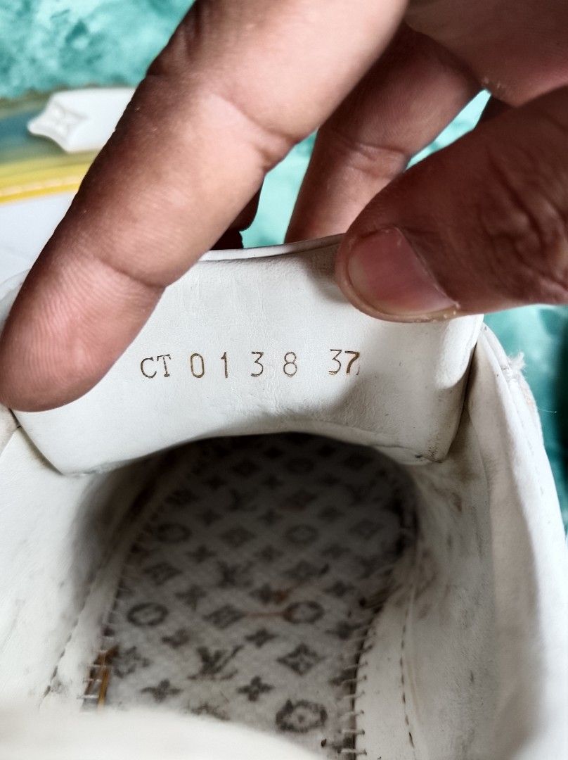 Louis Vuitton Time Out Sneaker White Monogram Size 37 (Category: Sneakers) located in Kapalong. Submitted by aliclothesfinds21 (Listing ID 1467365971, Image 3). Description: - Brand: Louis Vuitton - Style: Platform Sneakers - Color: White leather with blue accents & translucent yellow sole - Details: Iconic monogram canvas heel tab, gold-tone LV circle lace accessory, debossed monograms on sole - Size: Women's PH/EU 37 (Interior code: CT0138) - C