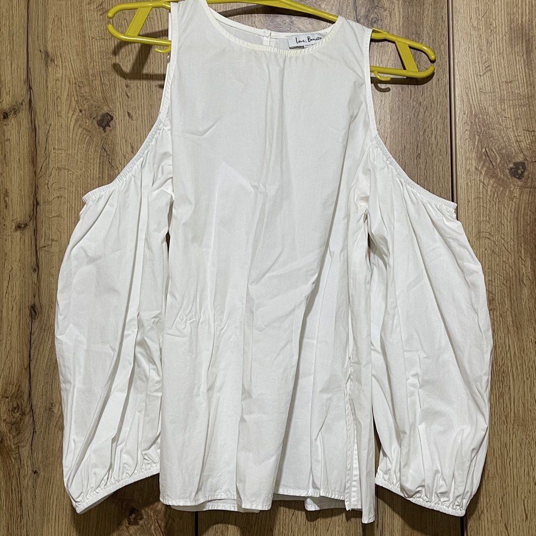 Love Bonito White Cold Shoulder Blouse Size S (Category: Blouses) located in Manila. Submitted by cluttercleanwme (Listing ID 1467584320, Image 1). Description: - Brand: Love Bonito - Color: Crisp white - Size: S (UK 8 / US 4, tag attached) but fits until medium since it’s flowy - Design: Cold shoulder with crew neckline and back button fastening - Sleeves: Long bishop sleeves with gathered cuffs - Material: High-quality cotton - Versatility: Per