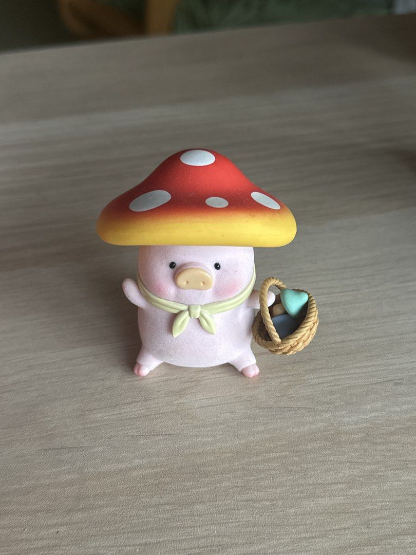 Lulu the Pig Basket (Category: Designer & Blind Box Toys) located in Quezon City. Submitted by shopfinesse (Listing ID 1467397887, Image 1). Description: - Adorable pig collectible featuring a red and yellow polka dot mushroom cap - Soft, detailed flocked texture all over the body - Holding a tiny woven basket filled with colorful miniature mushrooms - Wears a charming light green neckerchief - Measures a few centimeters tall, ideal for display s