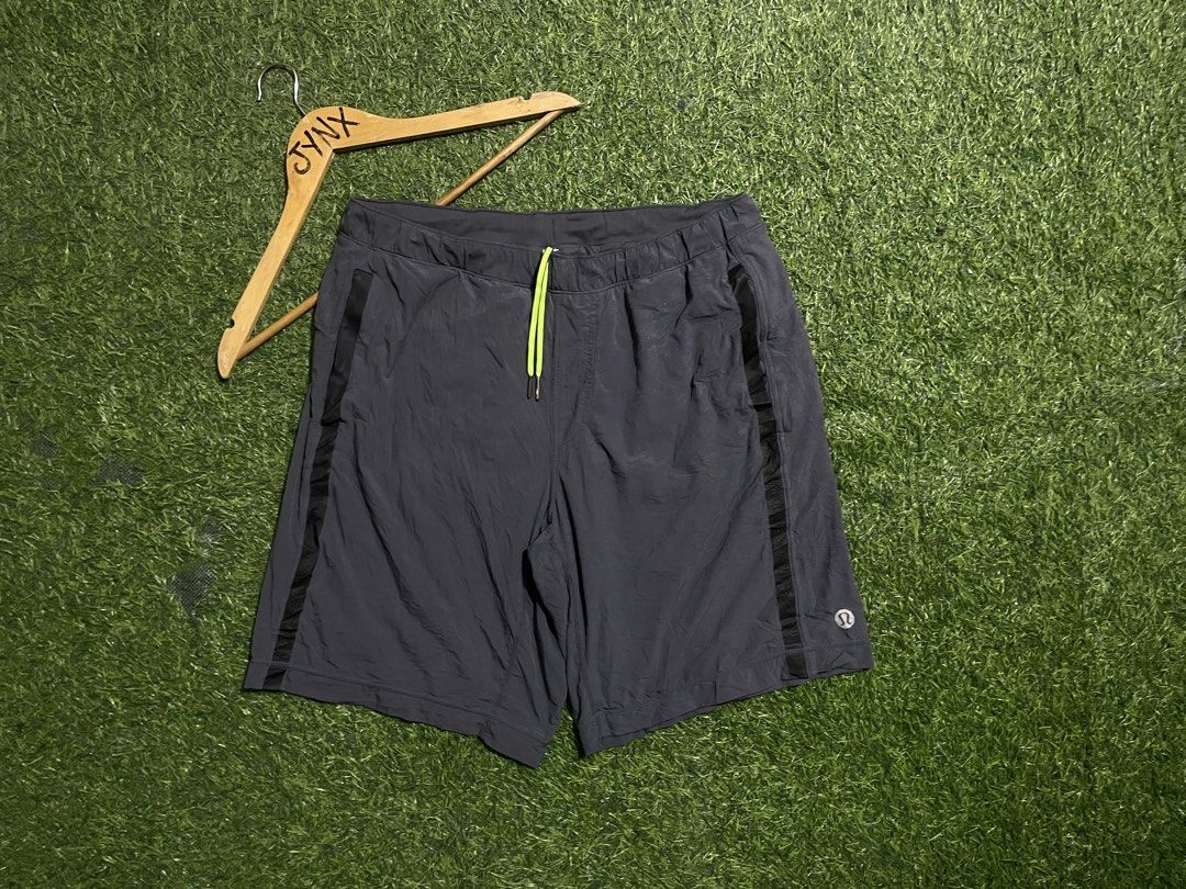 Lululemon Athletic Shorts Grey with Neon Yellow Drawstring (Category: Shorts) located in Las Pinas. Submitted by jynxdefant26140 (Listing ID 1467519844, Image 2). Description: - Brand: Lululemon - Color: Dark grey with neon yellow drawstring - Material: Lightweight, breathable athletic fabric - Features: Adjustable drawstring with branded metal tips, black mesh side panels for ventilation, small secure zipper pocket - Details: Reflective Lululemo