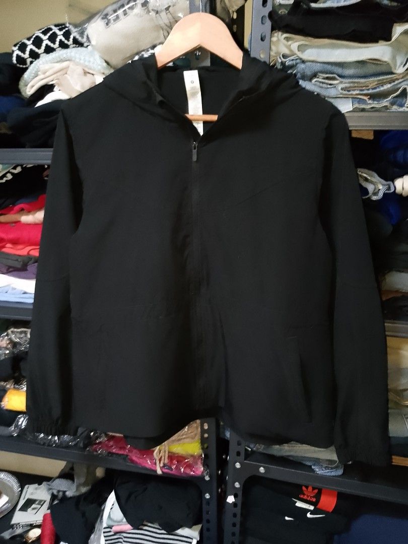 Lululemon Black Hooded Jacket Size 4 (Category: Coats, Jackets and Outerwear) located in Manila. Submitted by mjthrifted_second (Listing ID 1467420523, Image 1). Description: - Brand: Lululemon - Size: 4 (165/84A) -Dimes 20/26 - Color: Classic solid black - Material: Lightweight recycled polyester and elastane - Features: Full zip with signature logo pull, attached hood, adjustable drawstring hem, and reflective logo on sleeve cuff - Condition: E