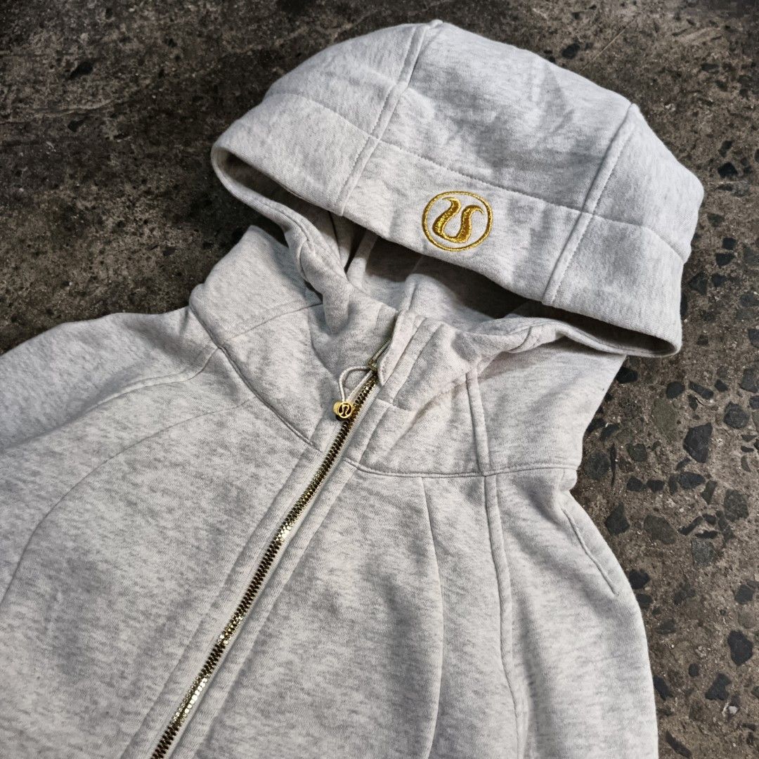 Lululemon Define Jacket Grey Gold Logo Size 4 (Category: Coats, Jackets and Outerwear) located in Caloocan City. Submitted by gemfinder669 (Listing ID 1467471608, Image 2). Description: - Brand: Lululemon - Style: Grey marled cotton zip-up hoodie - Size: 4 (170/80A) - Details: Shiny gold zipper, embroidered logo on hood, drawstring adjustments with gold hardware - Features: Built-in thumbholes on long cuffs, front pockets, structured fit - Condit