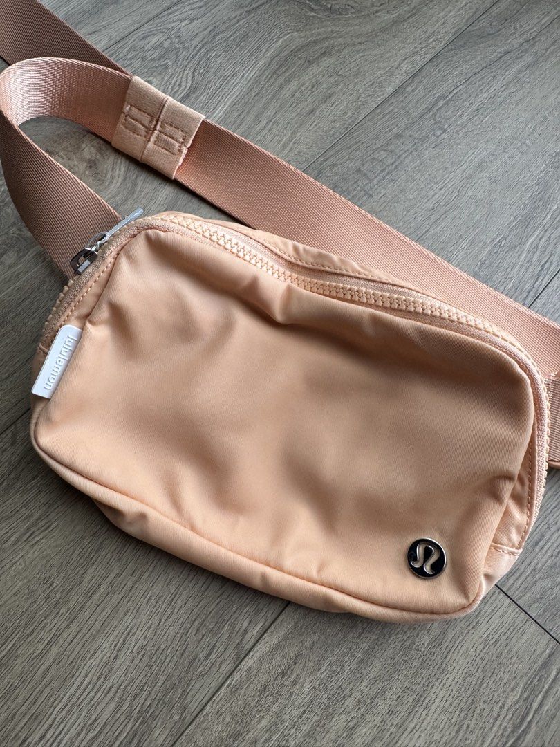 Lululemon Everywhere Belt Bag Peach Pastel (Category: Cross-body Bags) located in Davao. Submitted by Tineeee. (Listing ID 1467372253, Image 2). Description: - Authentic Lululemon belt bag in a gorgeous pastel peach shade - Compact and practical size, ideal for daily errands, walks, or travel - Secure zip-top main compartment with clean fabric exterior - Features the classic metal logo emblem at the corner - Equipped with an adjustable strap and 