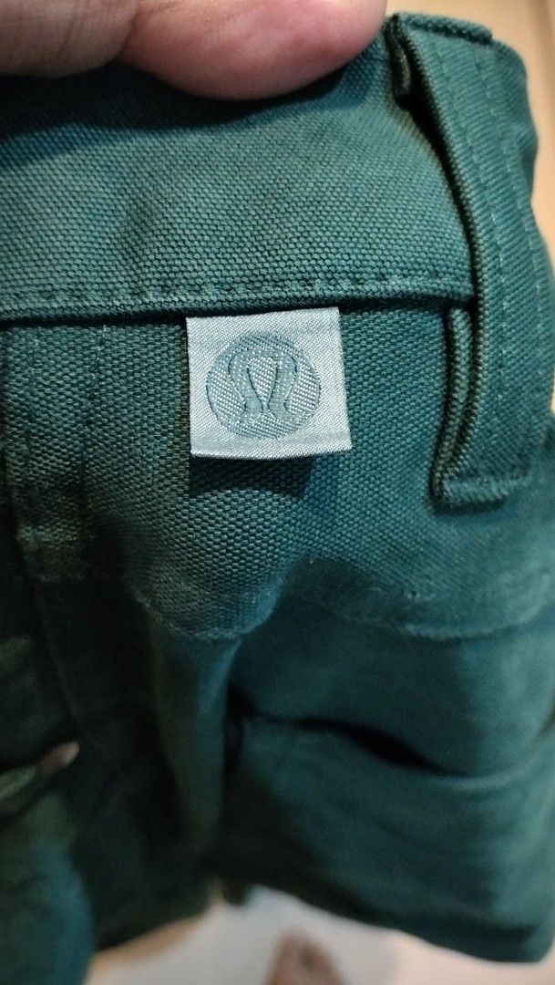 Lululemon Green Pants Size 32 (Category: Jeans) located in Angeles City. Submitted by mightywhale_13072f (Listing ID 1467411330, Image 3). Description: - Brand: Lululemon - Color: Dark Green - Size: Waist 32-33. L42 - Condition: very good - Details: Classic button closure, belt loops, functional back pockets - Branding: Subtle logo tag on back waistband and inside lining - Material: Durable, structured fabric.