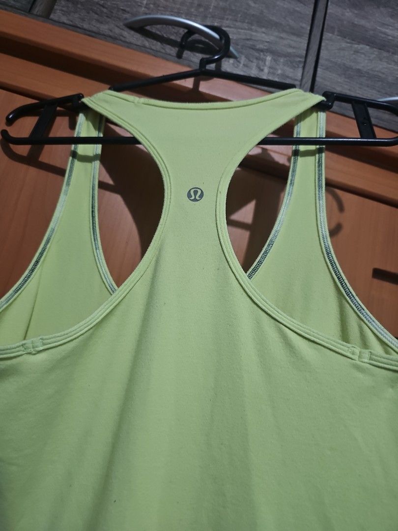 Lululemon Lime Green Racerback Tank Top (Category: Activewear) located in Lupao. Submitted by selahthriftedclothing (Listing ID 1467377917, Image 2). Description: - Brand: Lululemon - Color: Bright lime green - Style: Racerback tank top with exposed strap stitching - Details: Signature silver logo stamped on the back - Material: Super breathable, ideal for workouts or hot days - Fit: Form-fitting / fits close to the body - Versatility: Easy to st
