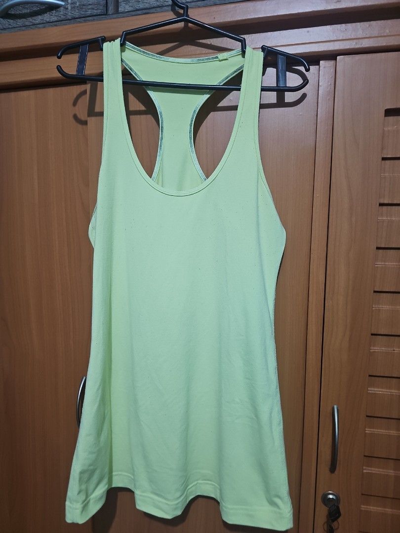 Lululemon Lime Green Racerback Tank Top (Category: Activewear) located in Lupao. Submitted by selahthriftedclothing (Listing ID 1467377917, Image 1). Description: - Brand: Lululemon - Color: Bright lime green - Style: Racerback tank top with exposed strap stitching - Details: Signature silver logo stamped on the back - Material: Super breathable, ideal for workouts or hot days - Fit: Form-fitting / fits close to the body - Versatility: Easy to st