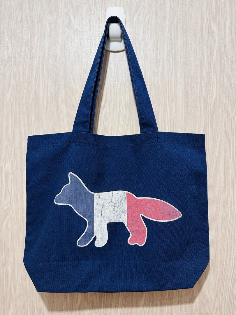 Maison Kitsune Tote Bag (Category: Tote Bags) located in Quezon City. Submitted by mikemofu (Listing ID 1467396350, Image 1). Description: Authentic Maison Kitsune Navy - London logo Issue: the printed logo is fading - it is common issue for this particular model.
