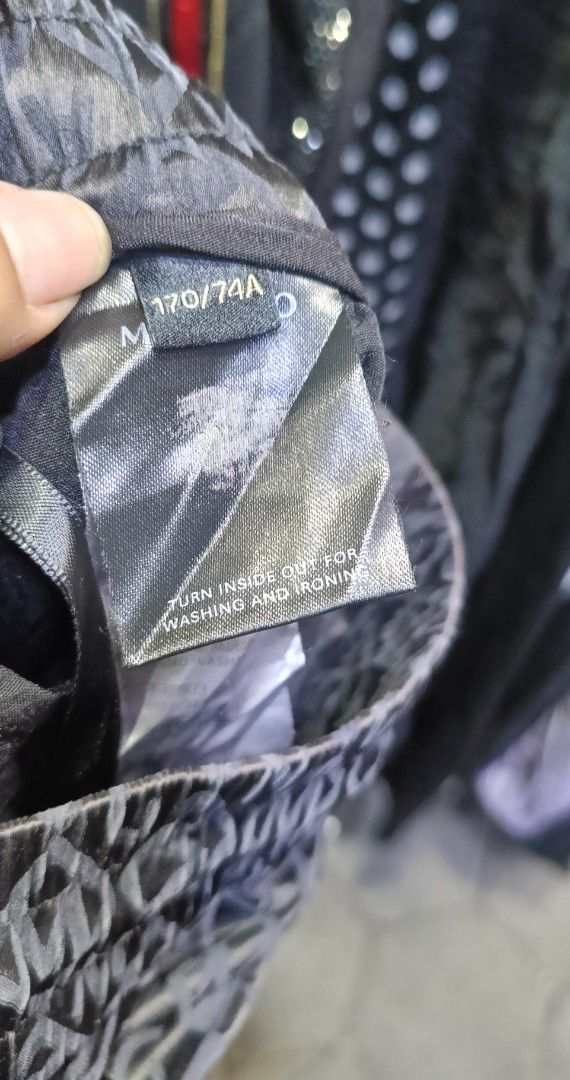Mangano patterned garment tag size 170/74A (Category: Formal Shirts) located in Rizal. Submitted by judithtillo19 (Listing ID 1467432179, Image 1). Description: - Brand/Item: Mangano piece - Design: Dark patterned fabric with a unique textured finish - Size: 170/74A - Care Instructions: Turn inside out for washing and ironing; hand wash or gentle machine cycle recommended to maintain fabric quality.
