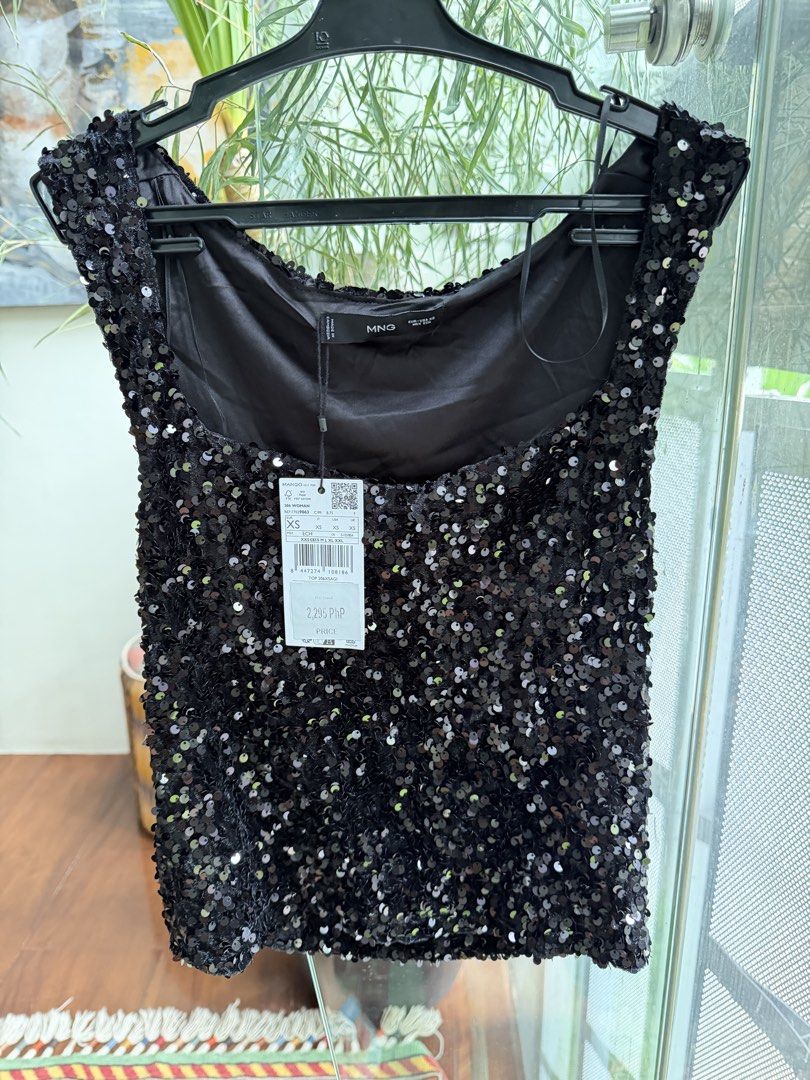 Mango Black Sequin Top (Category: Sleeveless) located in Quezon City. Submitted by mexpum (Listing ID 1467548408, Image 1). Description: - Condition: Brand new with original tag attached - Details: Scoop neckline, thick straps, fully covered in shiny black sequins on the front - Original Price: ₱2,295 - Ideal for: Parties, night outs, and special events.