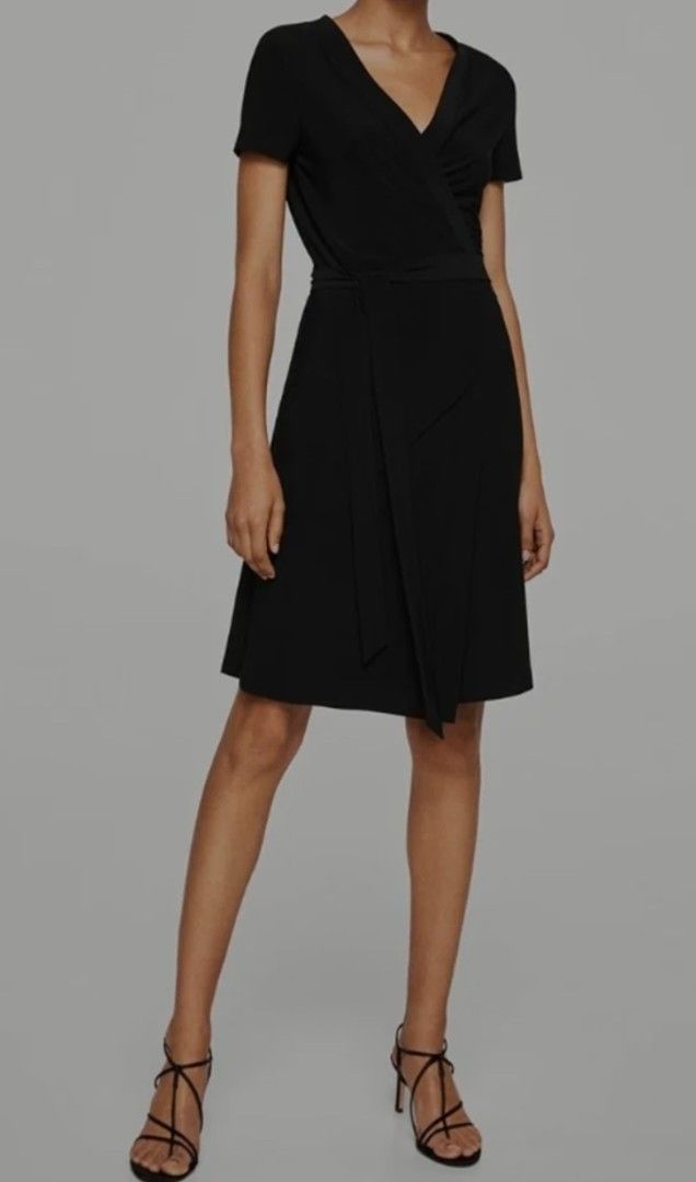 MANGO Black Wrap Dress Medium (Category: Dresses) located in Davao. Submitted by parenasnic86577 (Listing ID 1467602073, Image 2). Description: - Brand: MANGO - Color: Classic Solid Black - Size: Medium (True to size) - Design: Wrap dress with V-neck, short sleeves, and matching fabric tie belt - Length: Knee-length - Condition: Good staple piece - Styling: Easy to dress up or down for work or dinner.