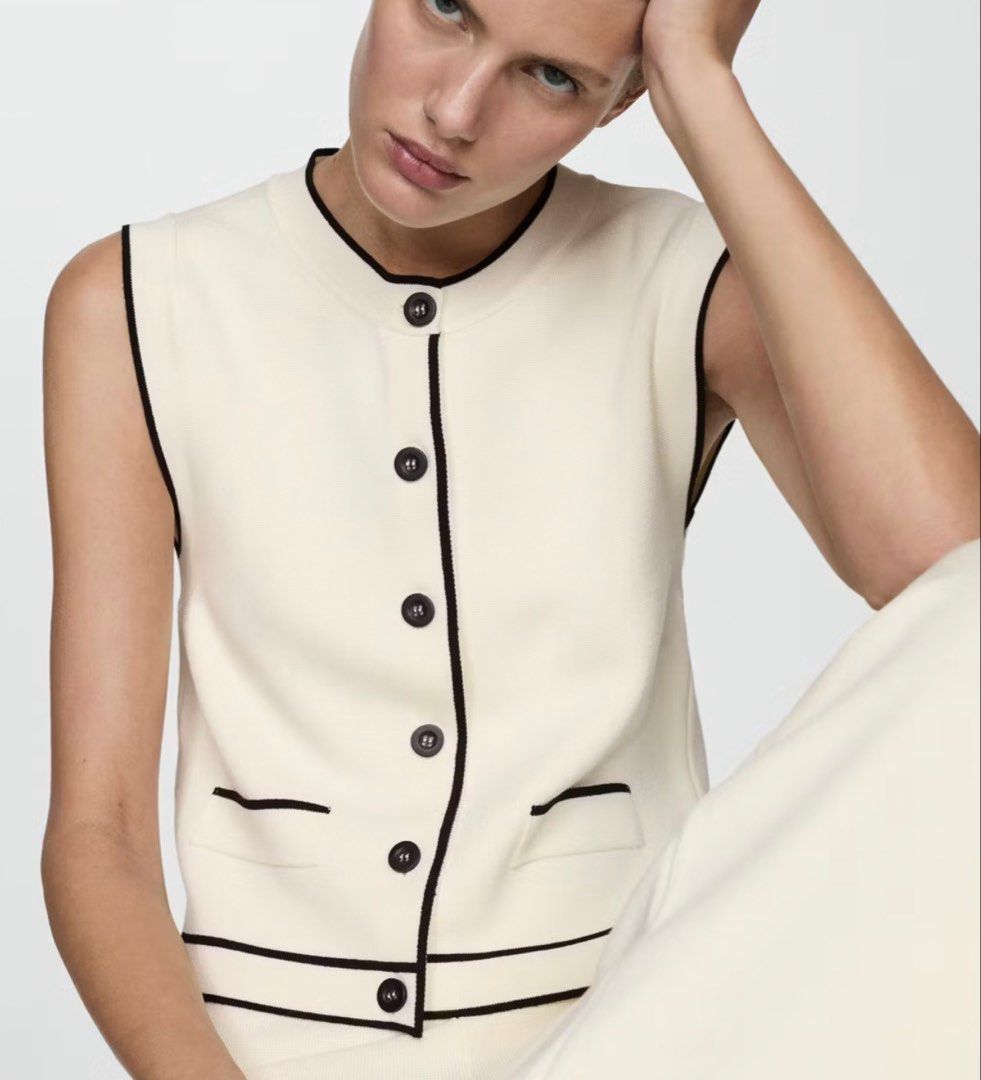 Mango Contrast Knit Vest Size S (Category: Sleeveless) located in Manila. Submitted by southie5 (Listing ID 1467540451, Image 1). Description: - Brand: Mango - Style: Knit vest with black trim details, round neckline, front button closure, and two front pockets - Color: Off-white - Size: S (Made in Turkey) - Condition: Clean, excellent, ready to wear - Perfect layering piece for transitional weather.
