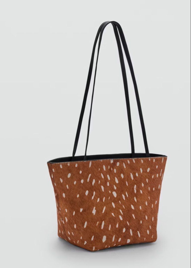 MANGO Deer Print Cowhide Shoulder Bag (Category: Shoulder Bags) located in Angeles City. Submitted by adeclutters__ (Listing ID 1467532106, Image 1). Description: - Brand: MANGO - Design: Brown and white deer print cowhide finish with matching black leather trim - Straps: Slim black leather shoulder straps - Interior: Dark lining with MANGO logo patch and a handy zip pocket - Style: Chic animal print accessory, perfect for daily use or special oc