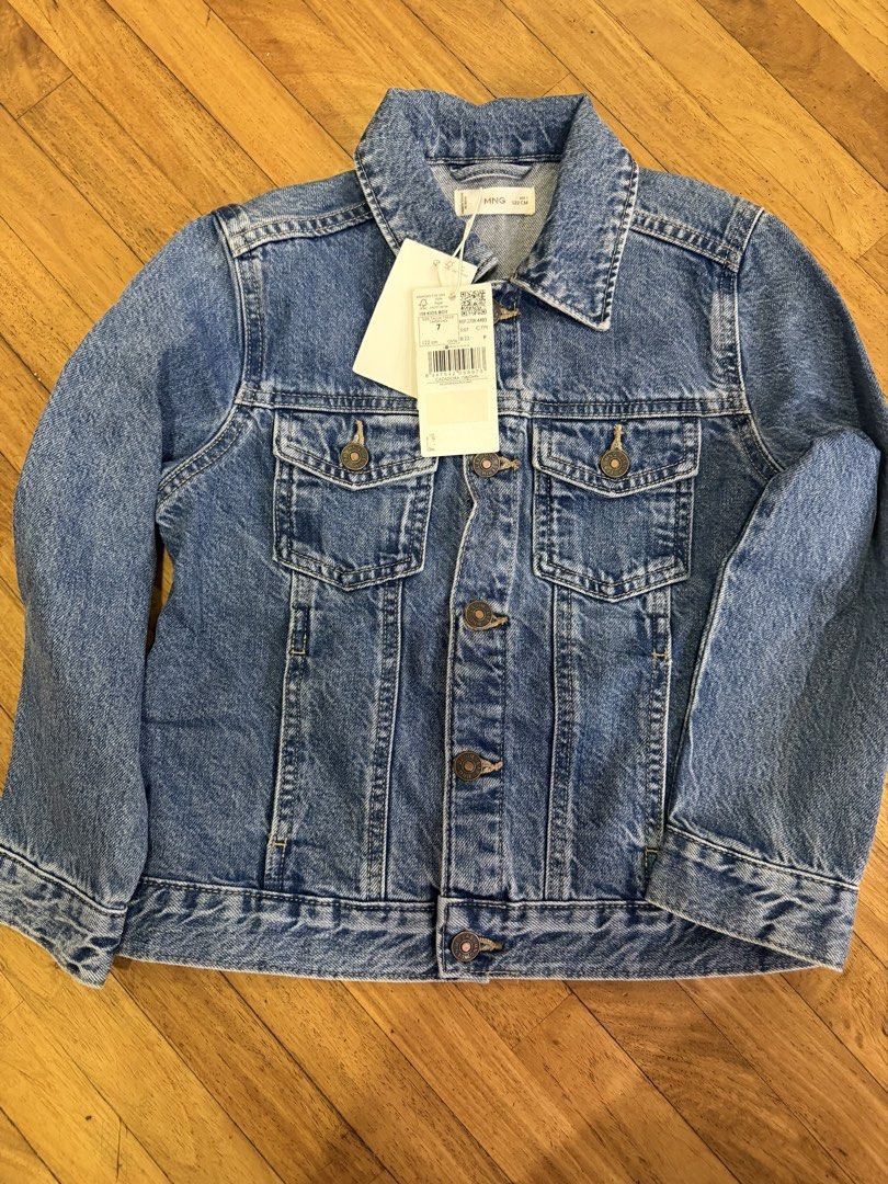 Mango Kids Boy Denim Jacket Size 122 cm (Category: Babies & Kids Fashion) located in Makati City. Submitted by goldenrabbit_605125 (Listing ID 1467384199, Image 1). Description: - Brand: Mango - Item: Kids Denim Jacket - Size: 122 cm / 7 years old - Condition: Brand new with original store tags attached - Color/Style: Classic blue wash - Features: Front button closure, dual chest pockets, and side welt pockets - Perfect for: Great everyday layeri