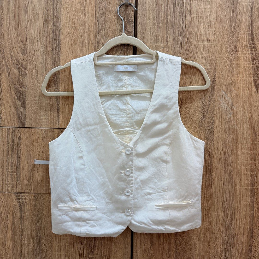 Mango Linen Waistcoat with Buttons White Size S (Category: Sleeveless) located in Manila. Submitted by m.south (Listing ID 1467522553, Image 3). Description: - Brand: Mango - Item: Linen Waistcoat - Color: White - Size: EUR-USA S / MEX CH - Details: Front button closure, two functional welt pockets - Fit: Clean silhouette, versatile for layering or standalone wear - Origin: Made in Vietnam - Condition: Excellent.