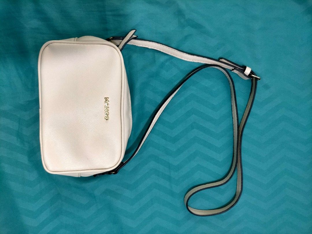 Mango off White Crossbody Bag (Category: Cross-body Bags) located in Iba. Submitted by pautheamitch (Listing ID 1467485939, Image 2). Description: - Brand: Mango, bought from the states - Color: off White with gold hardware lettering - Style: Compact crossbody bag - Closure: Top zipper - Strap: Adjustable - Interior: Black fabric lining with brand tag and original product label tag.