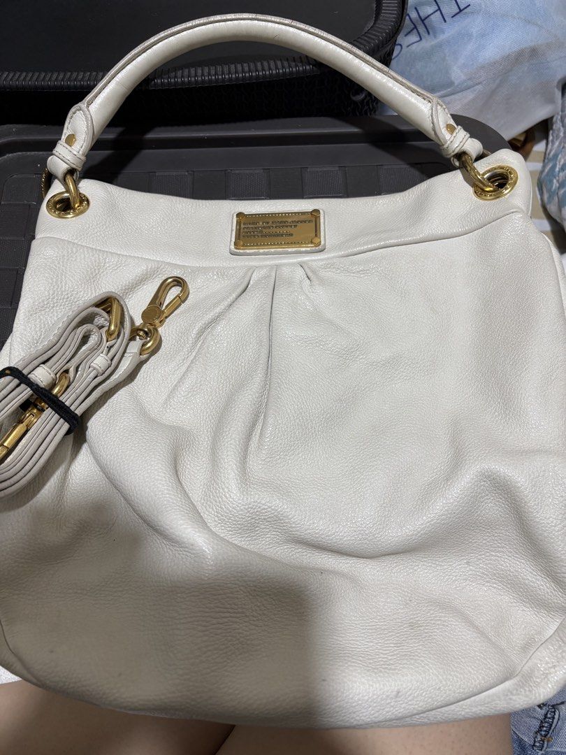 Marc by Marc Jacobs White Leather Shoulder Bag (Category: Luxury Bags & Wallets) located in Pasig City. Submitted by anenri (Listing ID 1467410051, Image 1). Description: - Brand: Marc by Marc Jacobs - Material: White textured leather - Hardware: Gold-tone with front metal logo plaque - Straps: Top handle plus an adjustable and detachable shoulder strap - Closure: Secure magnetic top snap - Interior: Monogram fabric lining with a convenient zip p