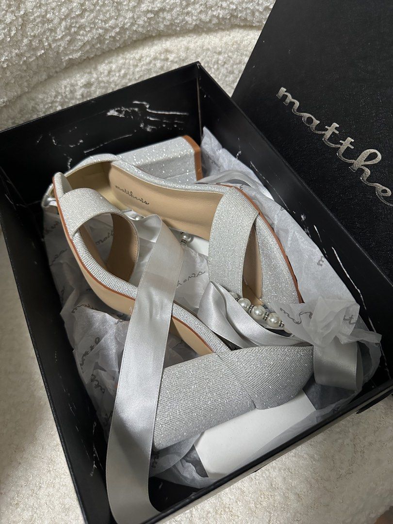Matthews Christa Heel Sandals Silver Size 36 (Category: Heels) located in Manila. Submitted by jmdrgooddeals (Listing ID 1467541490, Image 3). Description: - Brand: Matthews (Christa) - Color: Silver with sparkly finish - Size: 36 - Heel Type: Comfortable chunky heel - Design: Open toe, pearl detailing on ankle strap, and satin ribbon tie at the back - Condition: Like new, once worn during wedding ceremony only!! -Recently bought August 2026 - In