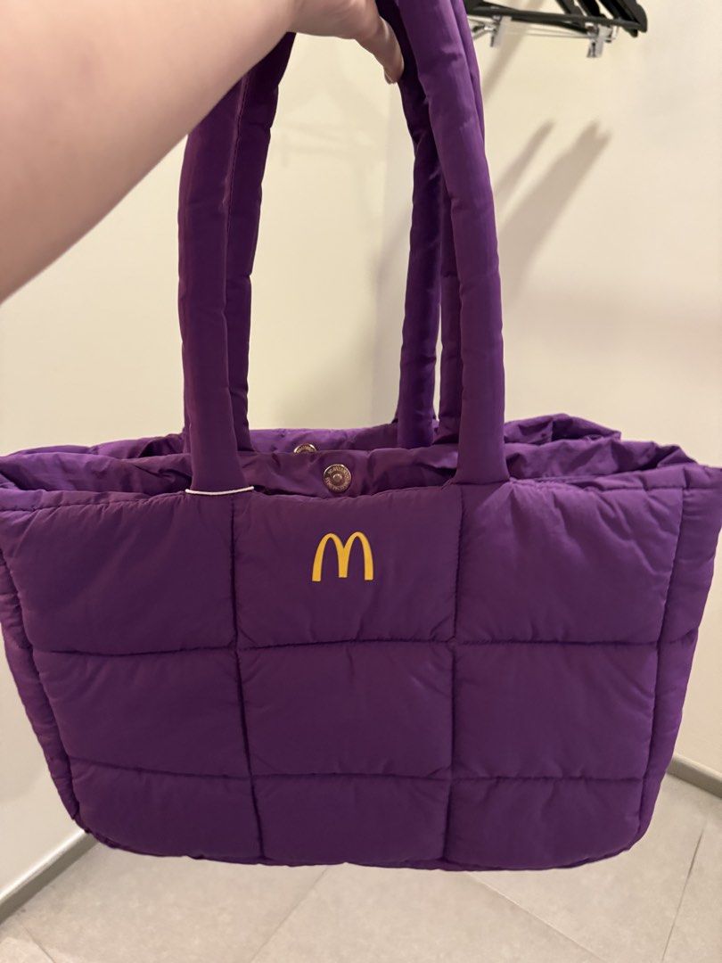 McDonalds Grimace Puffer Bag (Category: Tote Bags) located in Manila. Submitted by sjsy103006 (Listing ID 1467373077, Image 3). Description: - Authentic McDonald's Grimace Puffer Bag in vibrant purple - Quilted design with secure snap button closure and dual shoulder straps - Includes an exclusive Grimace plush keychain wearing a red McDonald's visor - Comes in original branded frosted zip pouch packaging - Brand new, perfect for daily use or as 