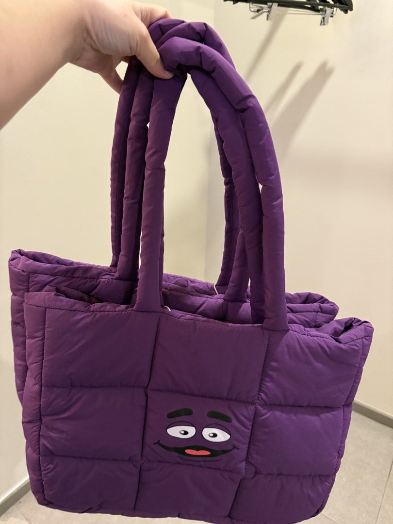McDonalds Grimace Puffer Bag (Category: Tote Bags) located in Manila. Submitted by sjsy103006 (Listing ID 1467373077, Image 1). Description: - Authentic McDonald's Grimace Puffer Bag in vibrant purple - Quilted design with secure snap button closure and dual shoulder straps - Includes an exclusive Grimace plush keychain wearing a red McDonald's visor - Comes in original branded frosted zip pouch packaging - Brand new, perfect for daily use or as 
