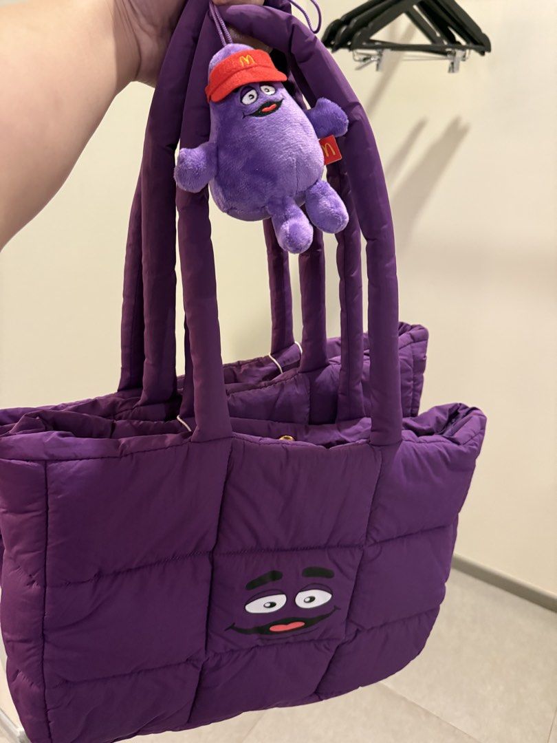 McDonalds Grimace Puffer Bag (Category: Tote Bags) located in Manila. Submitted by sjsy103006 (Listing ID 1467373077, Image 2). Description: - Authentic McDonald's Grimace Puffer Bag in vibrant purple - Quilted design with secure snap button closure and dual shoulder straps - Includes an exclusive Grimace plush keychain wearing a red McDonald's visor - Comes in original branded frosted zip pouch packaging - Brand new, perfect for daily use or as 
