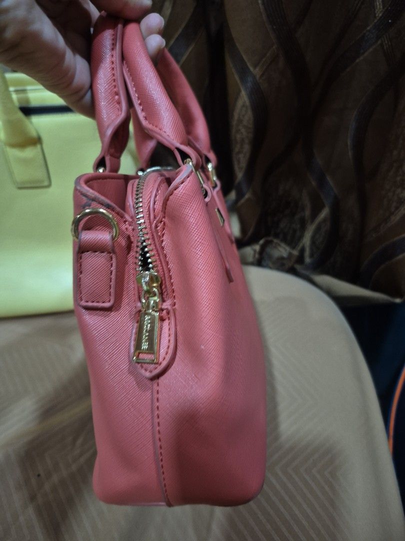McLane pink structured handbag with gold hardware (Category: Luxury Bags & Wallets) located in Iloilo. Submitted by gorgeoustatz (Listing ID 1467525667, Image 2). Description: - Brand: McLane - Color: coral with premium gold hardware - Material: Durable textured faux leather - Design: Structured shape with double top handles and secure zip closure - Storage: Convenient interior zipper compartment - Perfect for daily use or casual outings!.