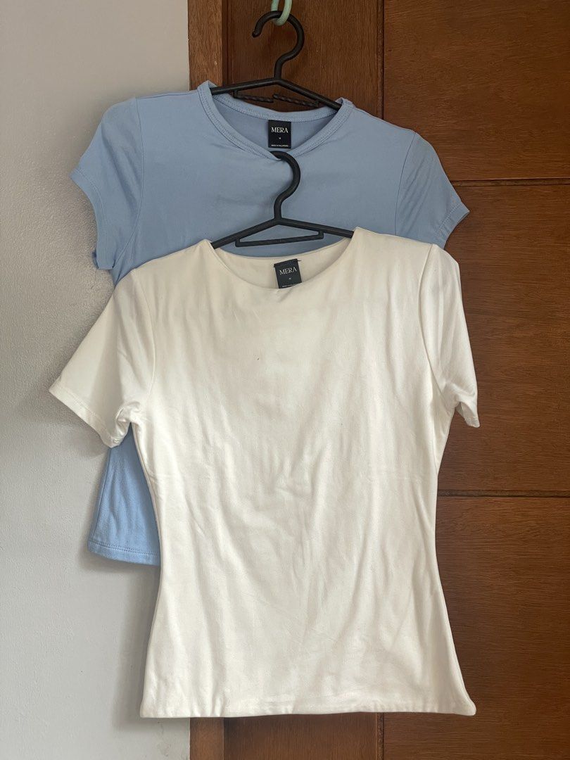 MERA Basic T-Shirt Bundle White and Blue Size M (Category: Shirts) located in Antipolo. Submitted by annagaskell (Listing ID 1467382595, Image 1). Description: ₱100 for both. Only worn once but they’ve been in my closet for over a year. Measurements available upon request. - Set of 2: White and Light Blue - Size: Medium - Fit: Fitted cut with short sleeves and round neckline - Versatile: Great for layering or wearing solo.