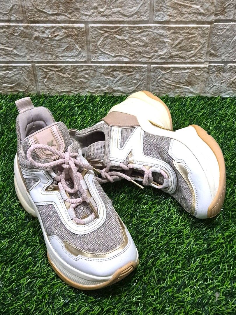 Michael Kors Glitter Chunky Sneakers Size: 5.5M (Category: Sneakers) located in Antipolo. Submitted by saribymonica (Listing ID 1460890195, Image 1). Description: - Michael Kors sneakers - Glittery mesh and white leather upper - Gold detailing - Pale pink lace-up closure - Comfortable chunky sole - Adds sparkle to any outfit - Minor signs of wear on soles and edges. Minimal color transfer. -- Authentic Michael Kors chunky sneakers - Chunky sole d