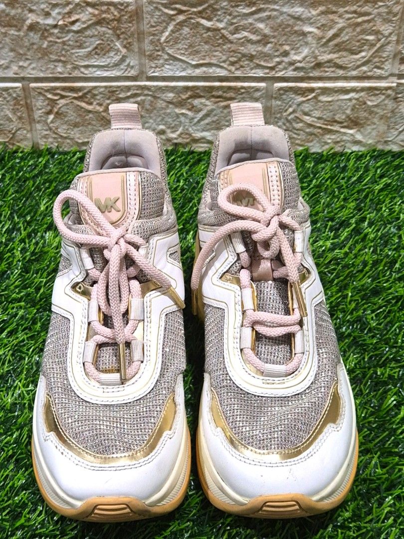 Michael Kors Glitter Chunky Sneakers Size: 5.5M (Category: Sneakers) located in Antipolo. Submitted by saribymonica (Listing ID 1460890195, Image 2). Description: - Michael Kors sneakers - Glittery mesh and white leather upper - Gold detailing - Pale pink lace-up closure - Comfortable chunky sole - Adds sparkle to any outfit - Minor signs of wear on soles and edges. Minimal color transfer. -- Authentic Michael Kors chunky sneakers - Chunky sole d