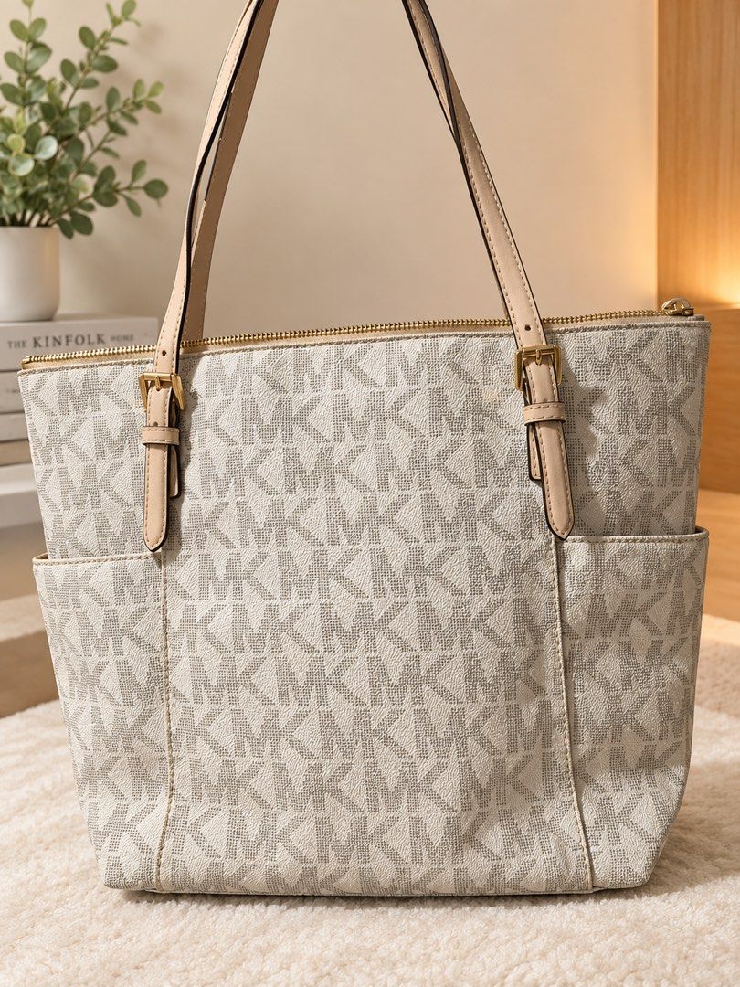 Michael Kors MK Monogram Tote Bag Cream Vanilla (Category: Luxury Bags & Wallets) located in Manila. Submitted by declutterwithpeanut (Listing ID 1467373526, Image 1). Description: - Authentic Michael Kors cream and vanilla tote bag - Signature MK monogram canvas exterior - Light beige leather shoulder straps with adjustable buckles - Premium gold-tone hardware and secure zip-top closure - Handy deep side pockets on the front - Clean, structured 