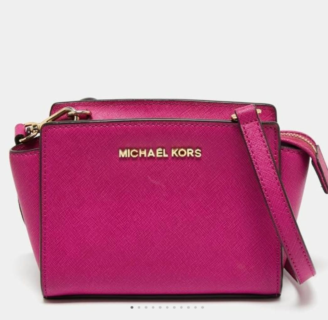 Michael Kors Pink Crossbody Bag (Category: Cross-body Bags) located in Manila. Submitted by talishang_ (Listing ID 1467602308, Image 2). Description: - Authentic Michael Kors crossbody bag in vibrant pink saffiano leather - Elegant gold-toned hardware and secure zip-top closure - Structured trapezoid shape with an adjustable shoulder strap - Compact yet spacious enough for your phone, keys, and small wallet - Super clean inside and out, ready to 