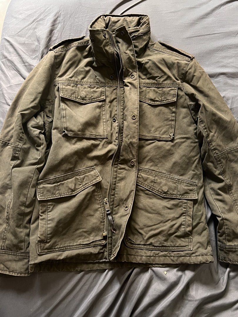 Military Style Olive Green Field Jacket (Category: Coats, Jackets and Outerwear) located in Manila. Submitted by vandetoria (Listing ID 1467386098, Image 1). Description: - Color: Olive green with a rugged washed finish - Closure: Full zip with front snap buttons - Pockets: Four large buttoned cargo pockets (chest and lower front) - Details: High stand-up collar and shoulder epaulets - Fit/Style: Great casual layer for cooler weather.