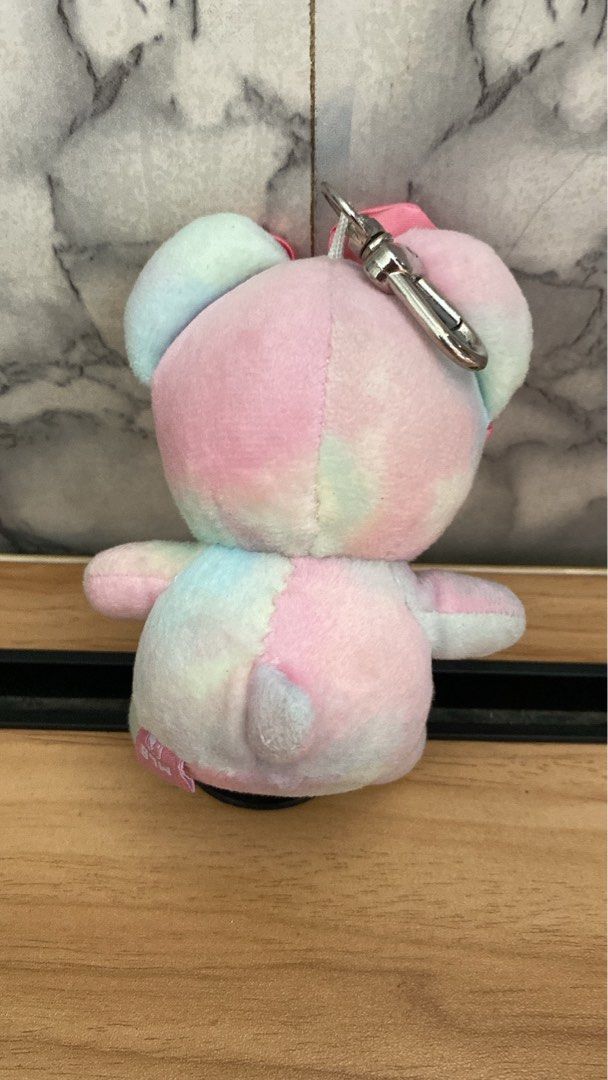 MLB Korea Mega Bear Plush Keychain (Category: Plushies & Soft Toys) located in Caloocan City. Submitted by izzyjelly (Listing ID 1467529764, Image 3). Description: - Authentic MLB pastel tie-dye bear plush keychain in pink, blue, and green tones - Features an embroidered New York Yankees logo on the chest - Adorned with a cute pink satin bow headband and an angry facial expression - Equipped with a sturdy metal lobster clasp for easy bag attachme