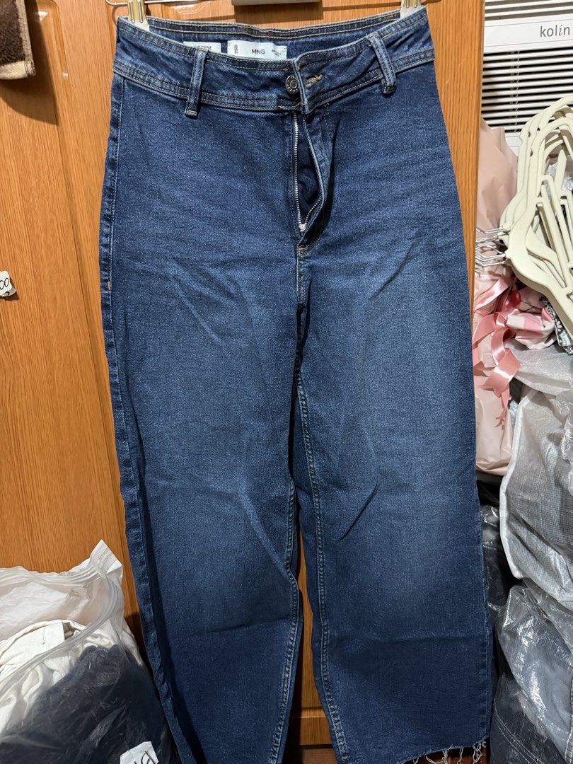 MNG Catherine Dark Blue Jeans (Category: Jeans) located in Muntinlupa City. Submitted by biancaagbscloset (Listing ID 1467538044, Image 1). Description: - Brand: MNG (Model: Catherine) - Color: Dark Blue - Fit: High waist with button and zipper closure - Design: Classic five-pocket style with belt loops - Detail: Trendy raw frayed hem at the ankles - Origin: Made in Pakistan - Condition: Great basic wardrobe staple, easy to style with casual tees