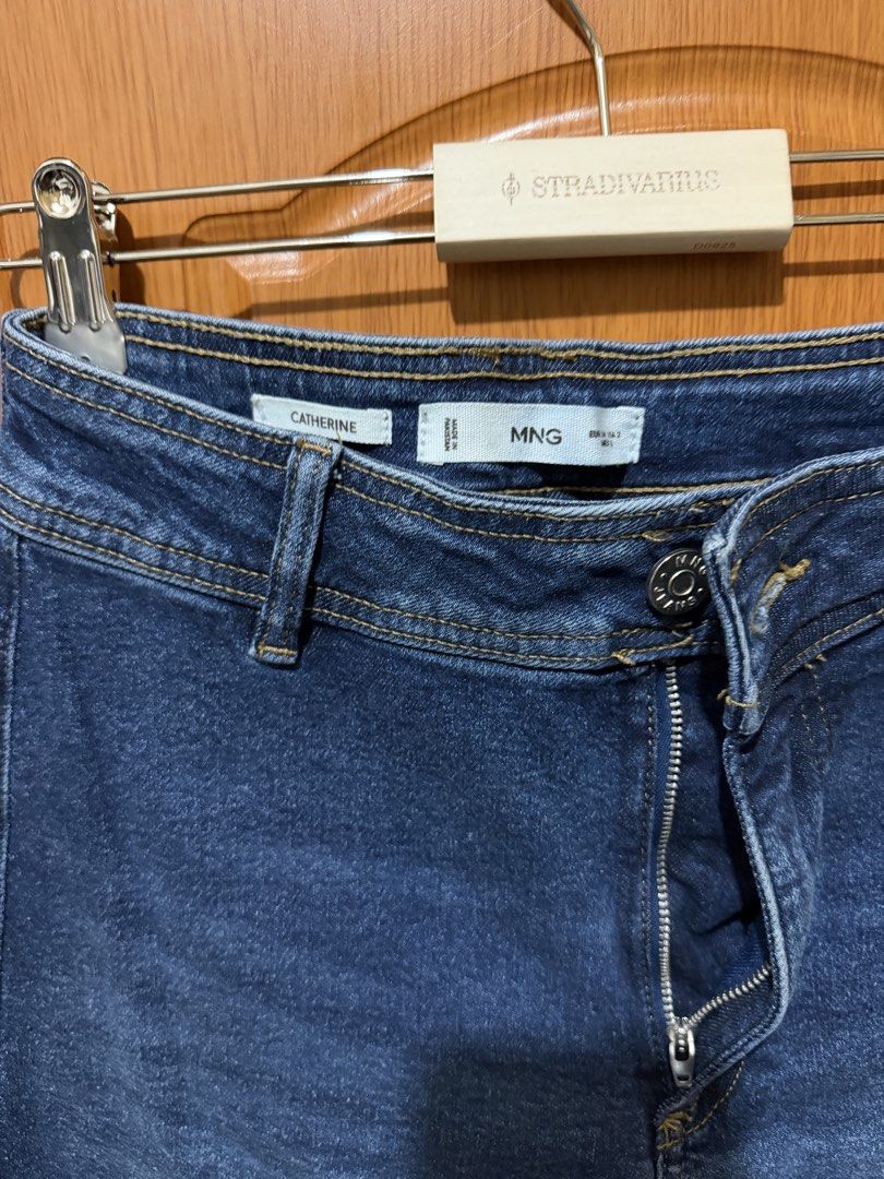 MNG Catherine Dark Blue Jeans (Category: Jeans) located in Muntinlupa City. Submitted by biancaagbscloset (Listing ID 1467538044, Image 2). Description: - Brand: MNG (Model: Catherine) - Color: Dark Blue - Fit: High waist with button and zipper closure - Design: Classic five-pocket style with belt loops - Detail: Trendy raw frayed hem at the ankles - Origin: Made in Pakistan - Condition: Great basic wardrobe staple, easy to style with casual tees