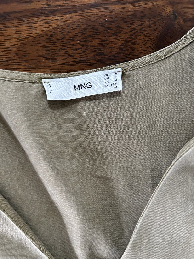 MNG Olive Green Button-Front Tiered Dress (Category: Dresses) located in Muntinlupa City. Submitted by manikascloset (Listing ID 1467395337, Image 3). Description: - Brand: MNG (Mango) - Size: Medium (EUR M / USA 6) - Color: Olive Green - Design: V-neckline with 3 dark front buttons, short puff sleeves, layered tiered skirt - Material: Lightweight fabric with a soft finish - Condition: great / Pre-loved - Mode of Payment: BPI/Metrobank - Shipping