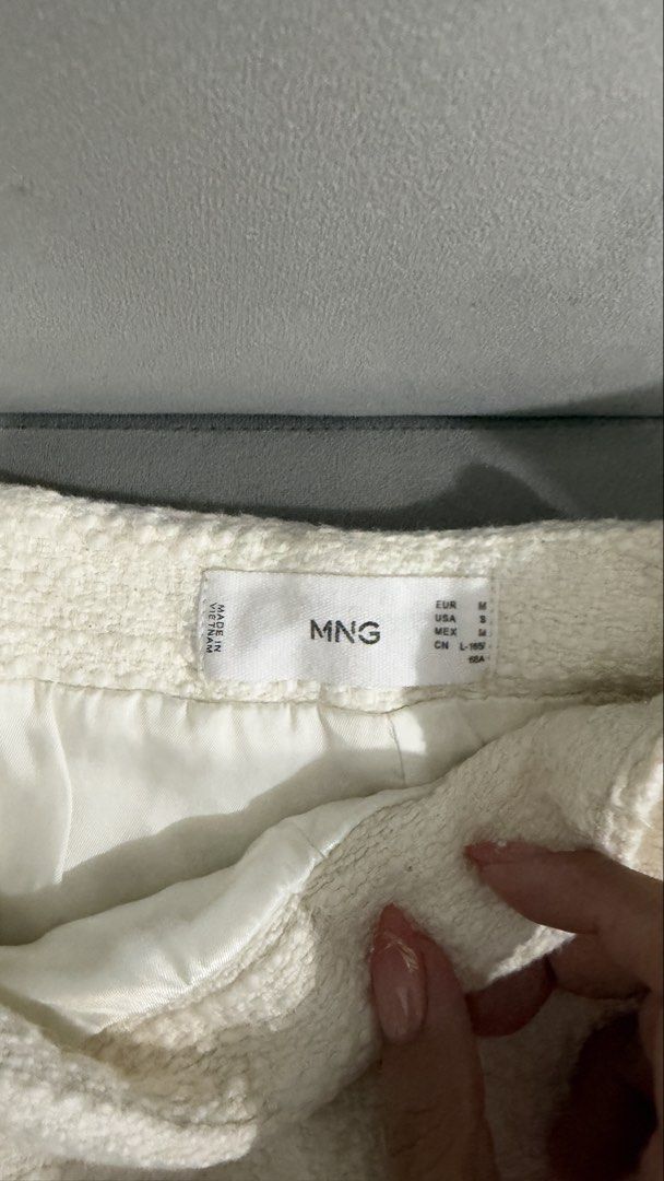 MNG White Tweed Skirt Size M (Category: Skirts) located in Quezon City. Submitted by dalynsantos (Listing ID 1467370482, Image 2). Description: - Brand/Style: Mango white tweed skirt - Fabric: Structured tweed with a smooth interior lining - Closure: Hidden zipper at the back.