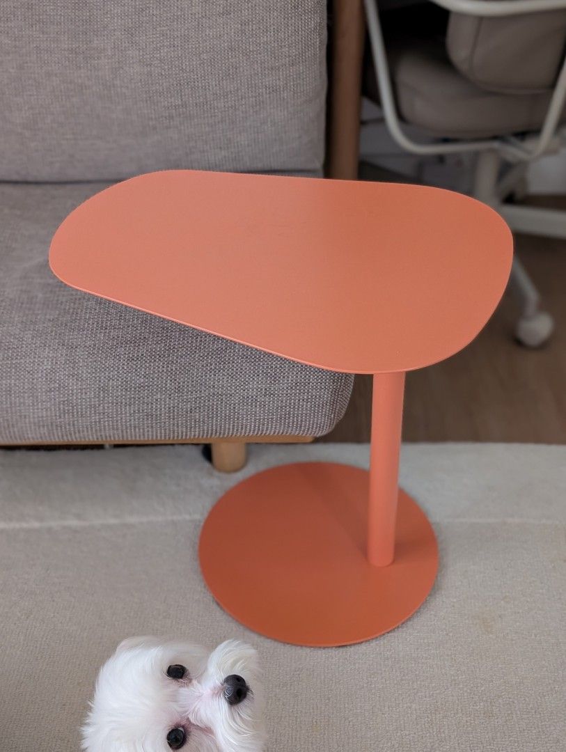Modern Coral Orange Accent Side Table C Table (Category: Tables & Sets) located in Pasig City. Submitted by michi.a (Listing ID 1467561803, Image 1). Description: - Color: Coral Orange - Design: Pebble-shaped top with a round metal base - Condition: Clean, minimal signs of handling - Style: Minimalist and modern - Placement: Ideal next to a sofa, armchair, or in the living room.